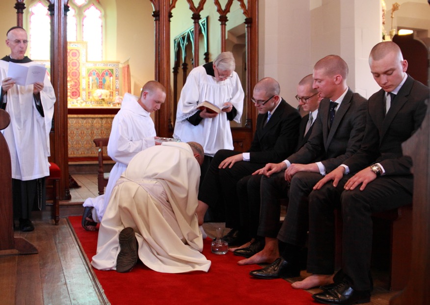 Father Prior washes the feet of the to be clothed postulants.