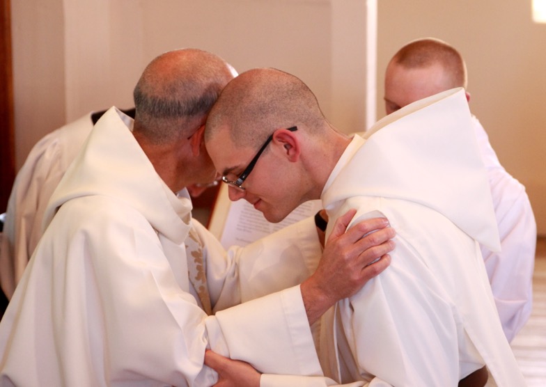 Giving the kiss of peace to Brother Bede Mary.
