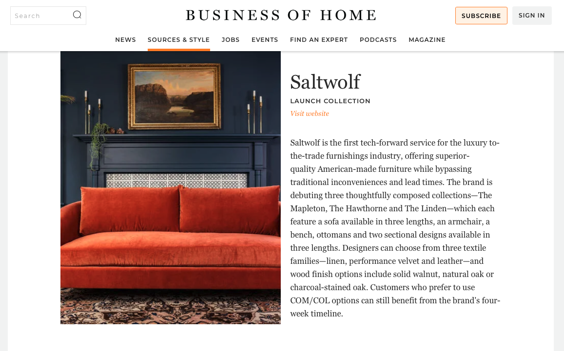 A website page from Business of Home featuring Saltwolf furniture collection, with an orange velvet sofa in a living room setting, a dark blue wall, a painting, and decorative candles.