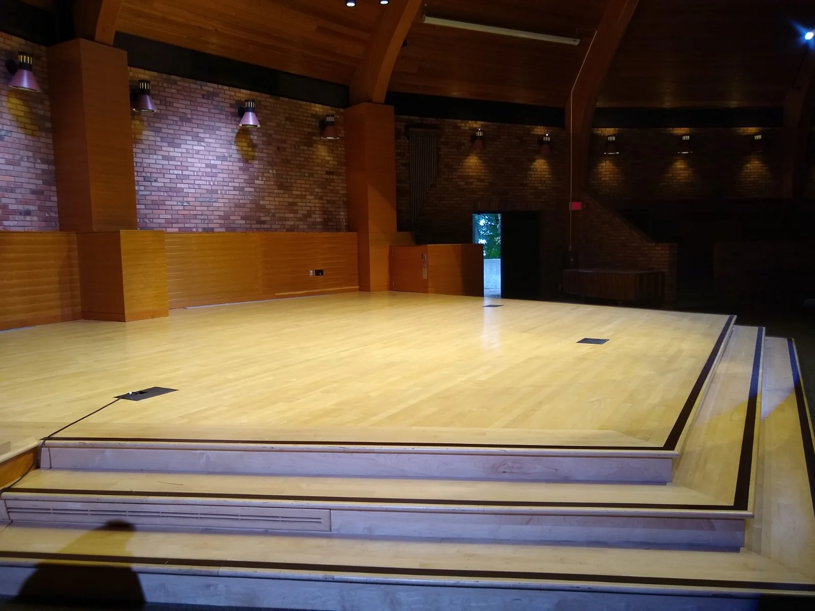 Stage, without decorative flats or curtains across back. (there will be lights and monitors along the edge of the stage, but plenty of space between them. )