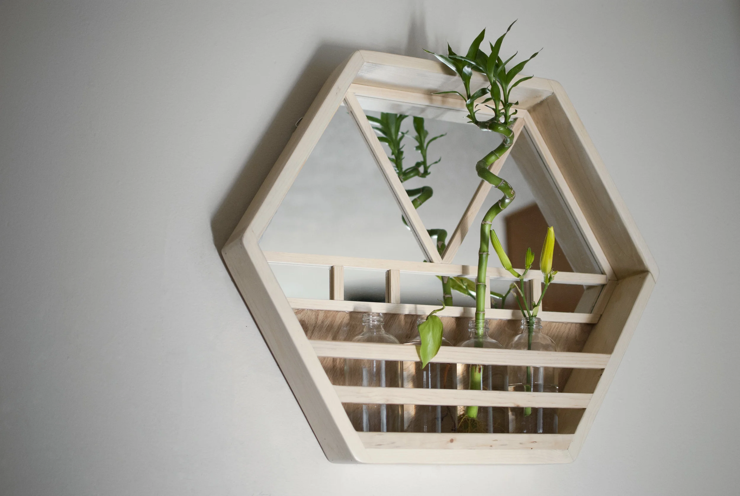 Chuck made this hexagonal wall planter from reclaimed wood and mirrors. The jars currently house bamboo and freshly cut daylilies. It's so fun to wait for those flowers to open up!