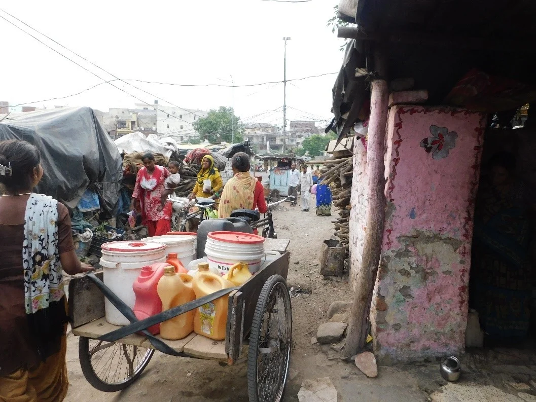 Women carting water collected to their homes from the public taps in Bhainsa Tibba, Panchkula (Source: Kanchan Gandhi, 2019)
