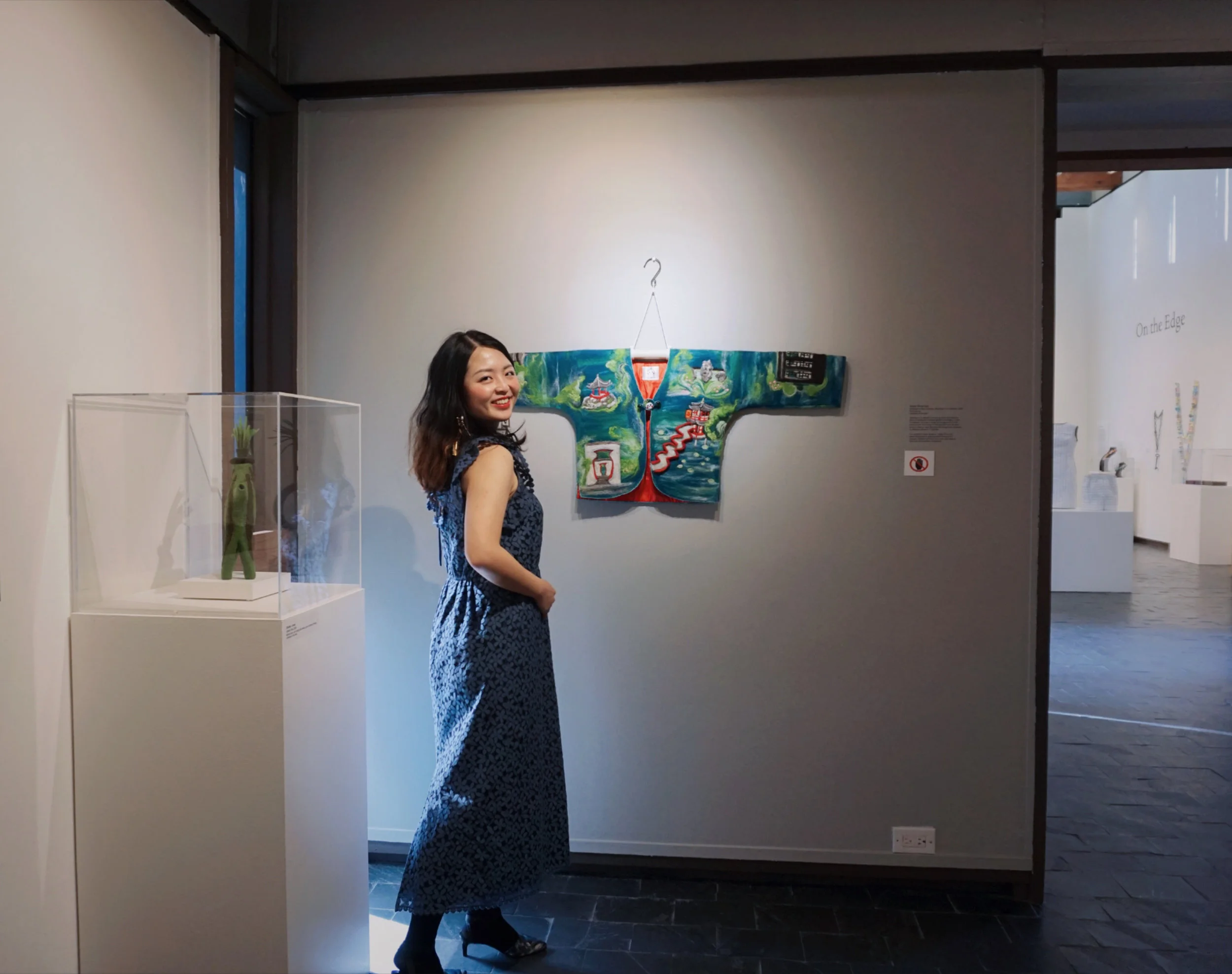 Artist Teasy Shiruo Sun in front of her art work.