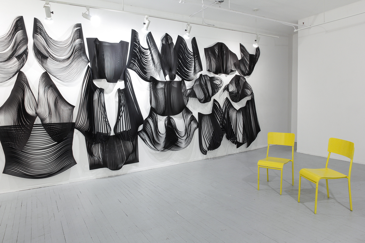 Interstitial , detail of installation of hand and laser cut paper, yellow chairs, 10' x 38', 2016.