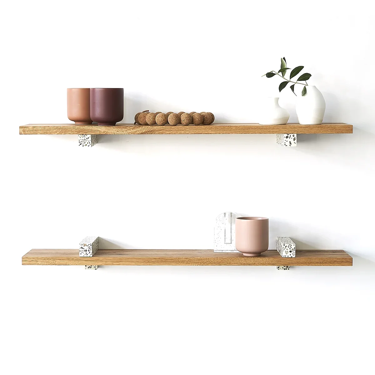 Hangul minimalist floating shelves featuring terrazzo brackets and natural oak wood, styled with ceramic vases and decor.