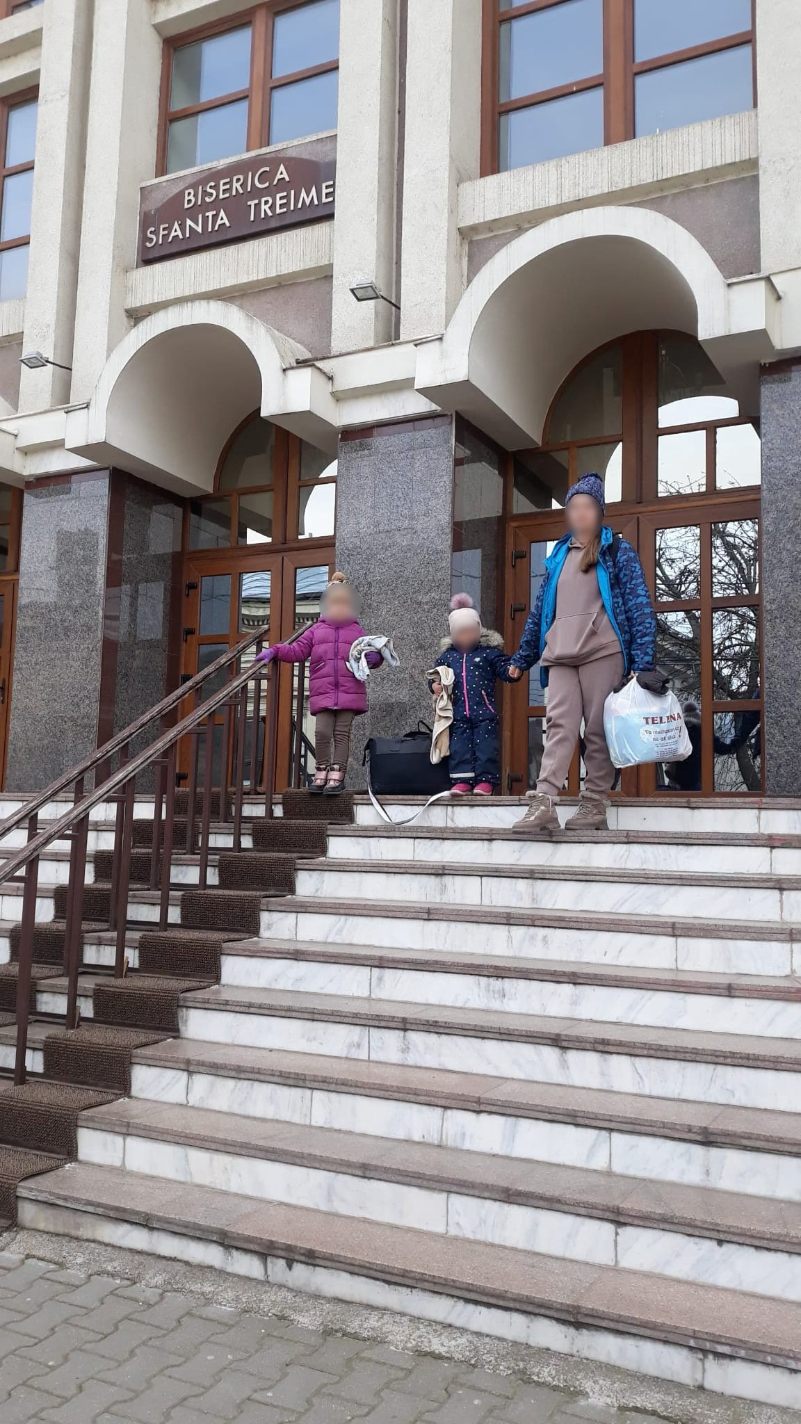 Ukrainian family in front of church.jpeg