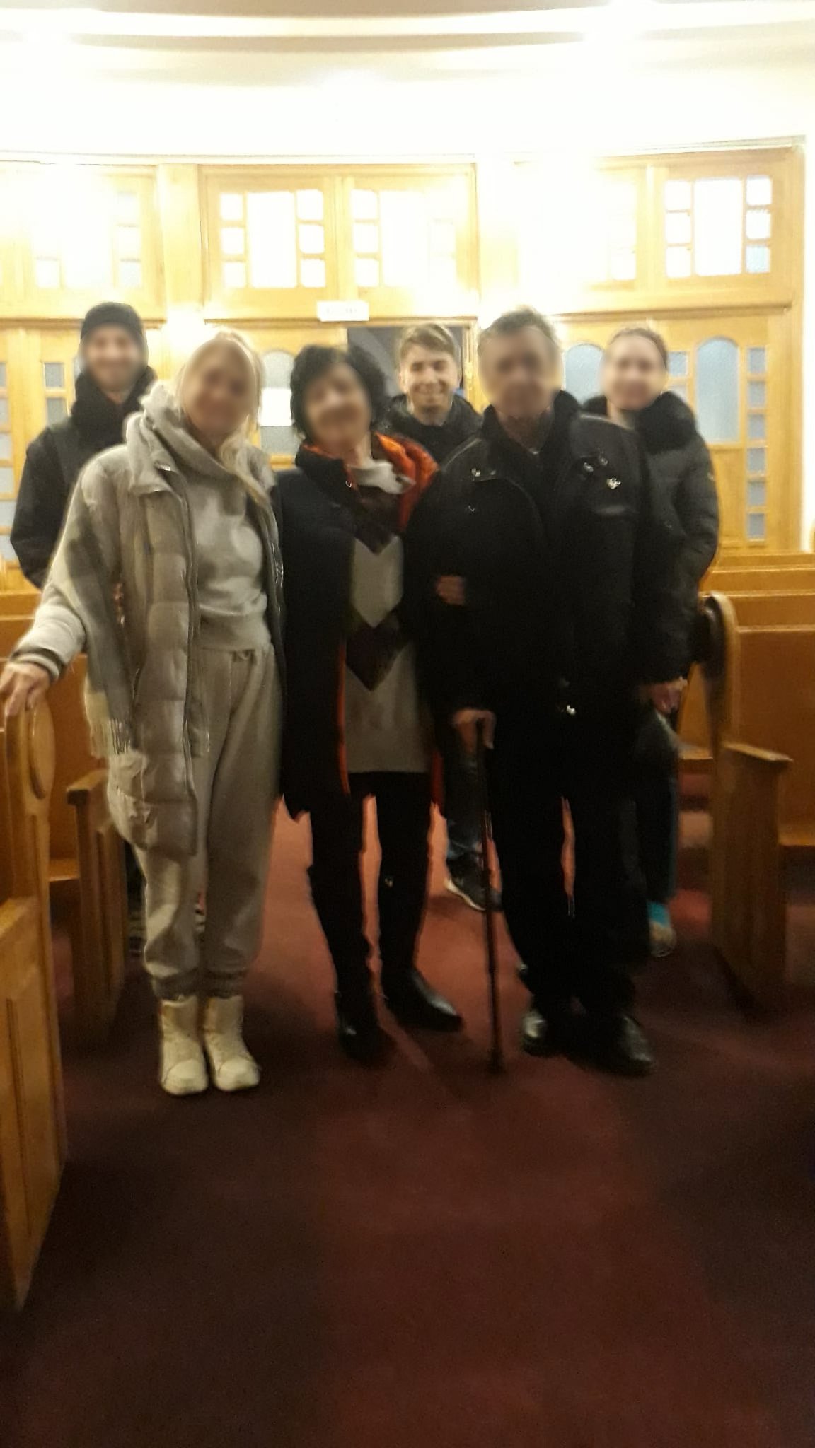 Ukrainian refugees with Pastor Iosua at Bralia Romania partner church.jpeg