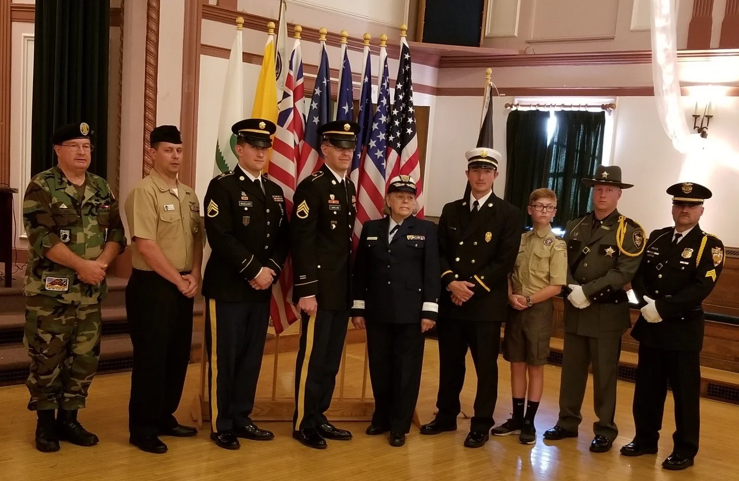 Pictured are the Flag Carriers: A veteran (member Tim Caldwell), active duty service men and woman, a fireman, a boy scout, a Licking County Sheriff Deputy (member Justin Woodyard) and a city policeman.