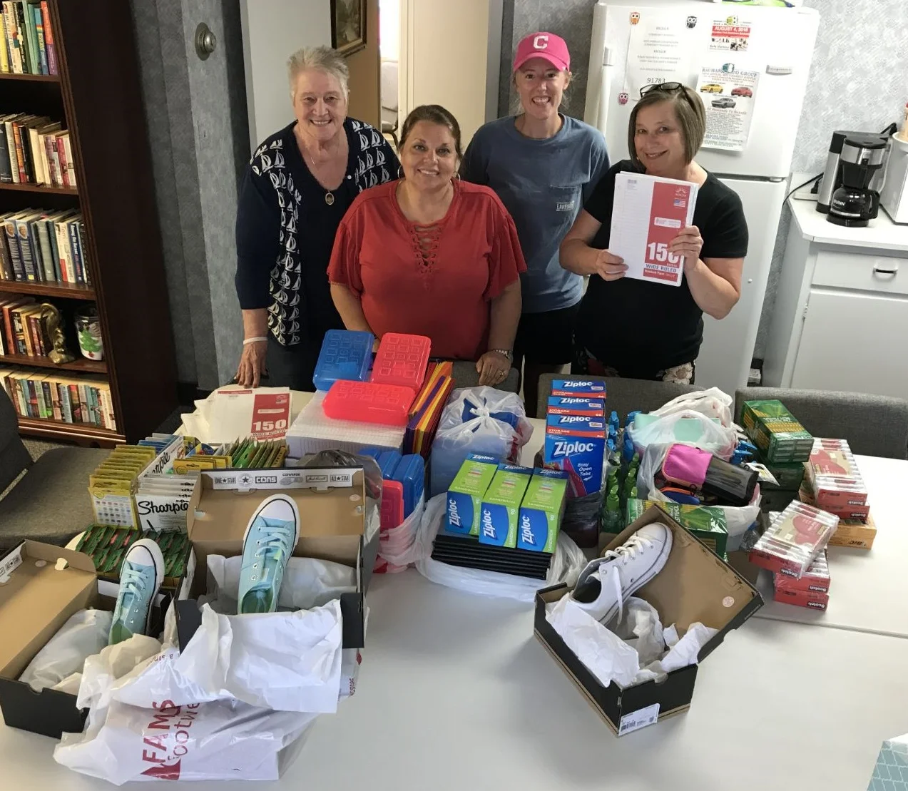 Pictured, from left: Safe Harbor director Linda Mitchell, Beth Wimmer, Hannah LeBran and Hazel Foley with a very small portion of the latest items donated to the shelter.