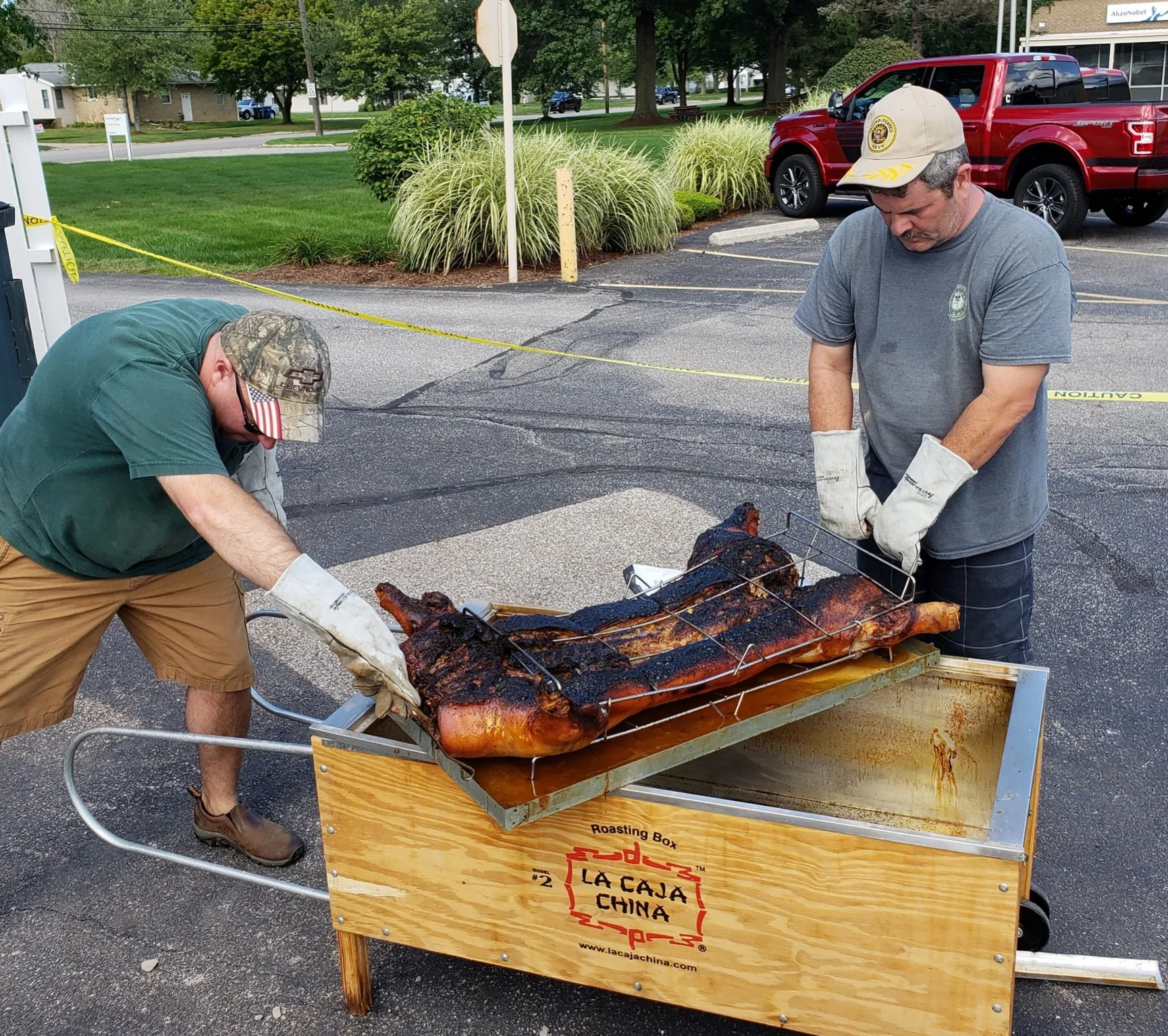 Trustees Nate Moore and Hank Nest worked hard to prepare the pig.