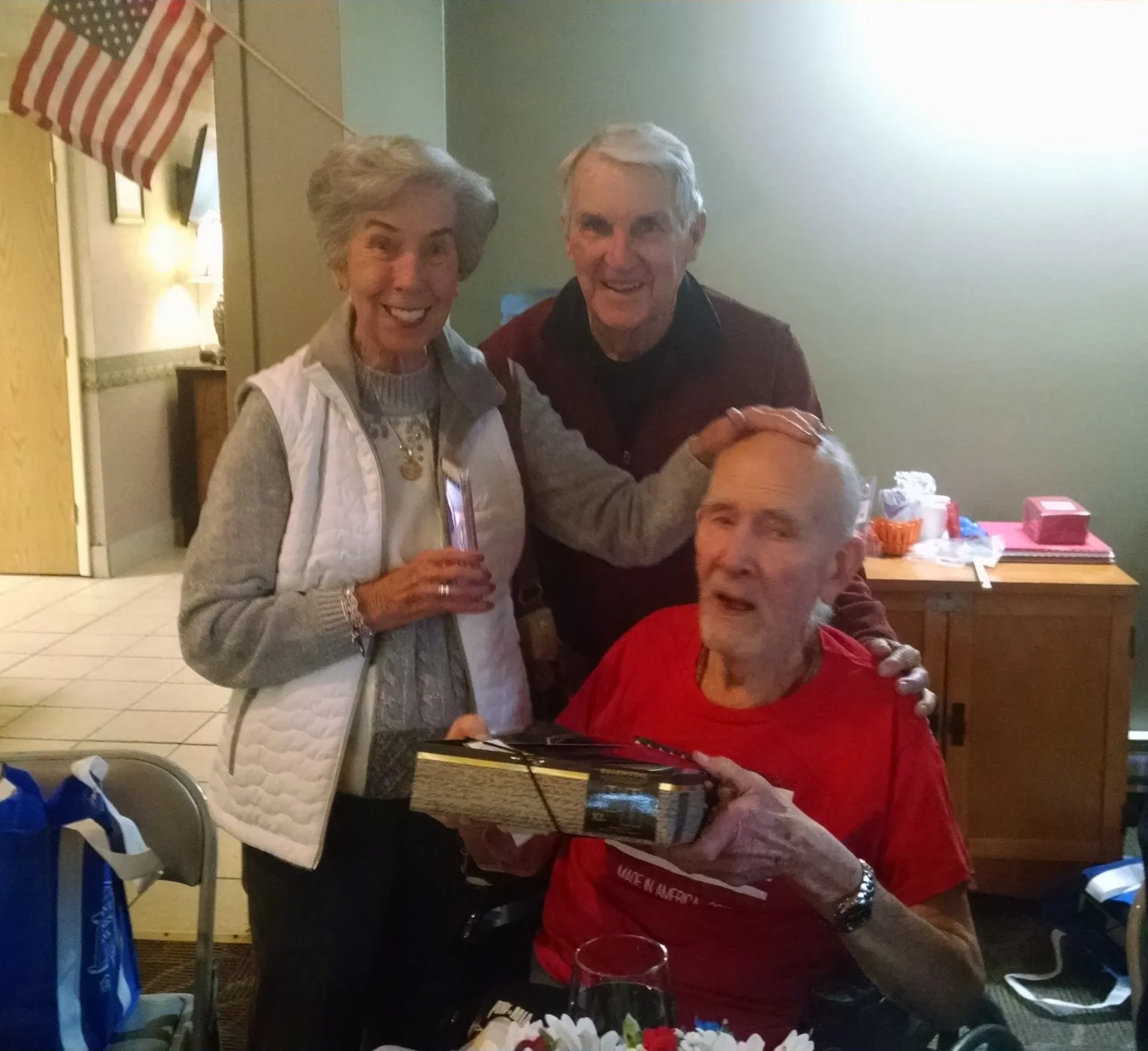 This photo shows a veteran at Country Club Retirement receiving his new pajamas, purchased with a Freedom Grant from the Elks National Foundation. Each veteran at four local nursing homes got a pair of warm pajamas, slippers and a bag of comfort items donated by local school children. These were presented at their Veterans Day Program. Tom and Peggy Cusick are shown in the photo giving a gift to a veteran at the nursing home in Bellaire.