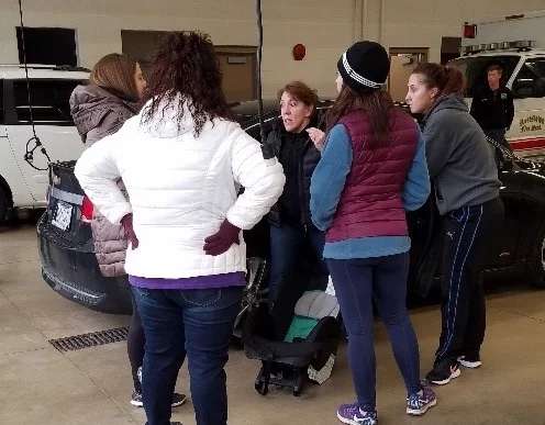 Becky Lehman (middle) Director of Health Education from the Health District instructs new mothers.