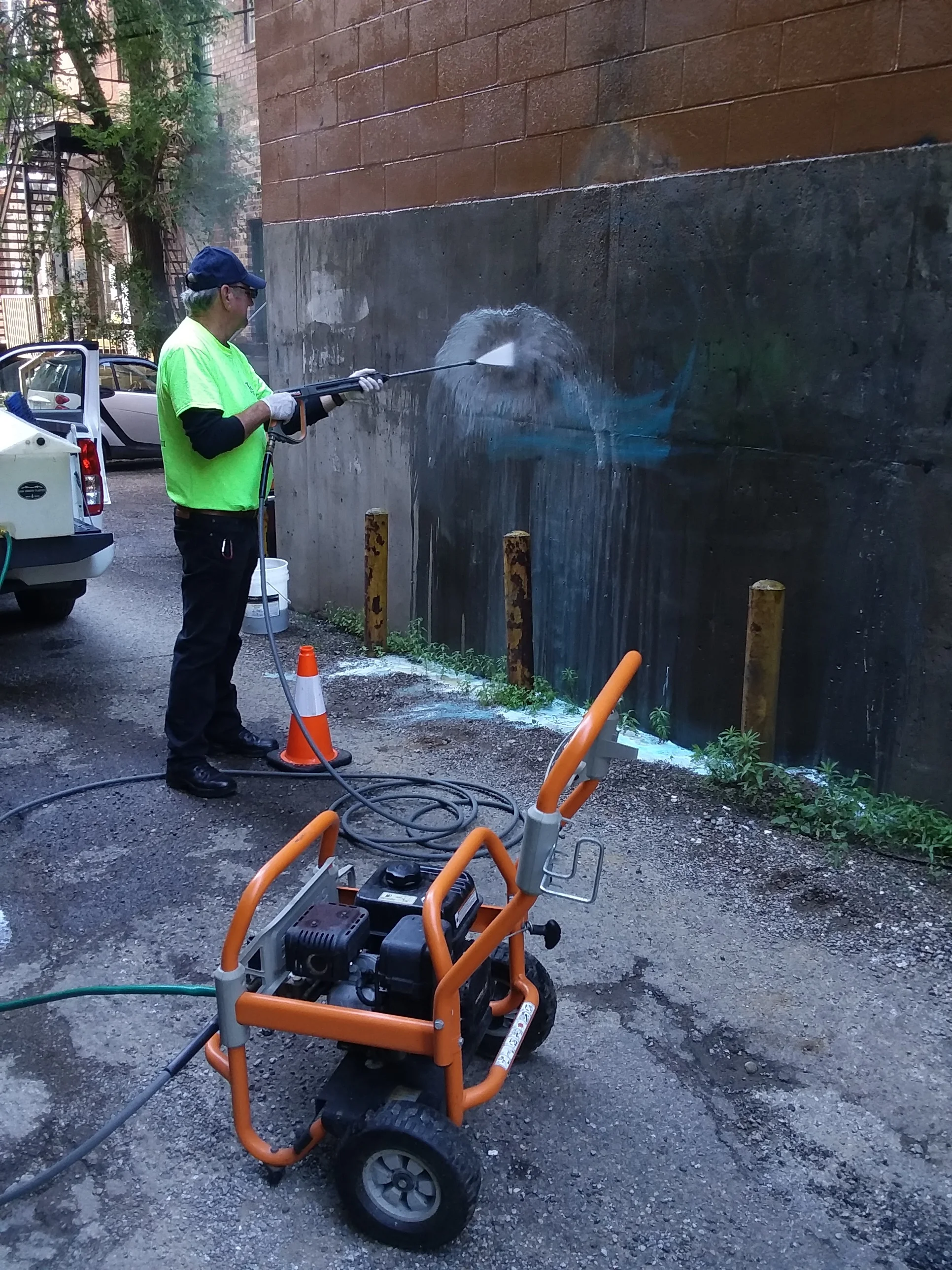 Pictured: Elks member Dave Williams using the power washer to remove the graffiti