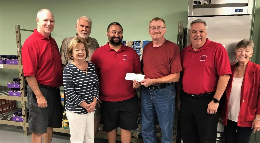 Fremont Elks Exalted Ruler Mike Sanchez, center left, presents a check for $2,000 to Jim Faist, treasurer of the Sandusky County Food Pantry. Others in the picture are, from left, Elks Trustee Mike Kelly, Roy and Marty Wilhelm of the food pantry, and Elks trustees Rick Frank and Billie Lee.