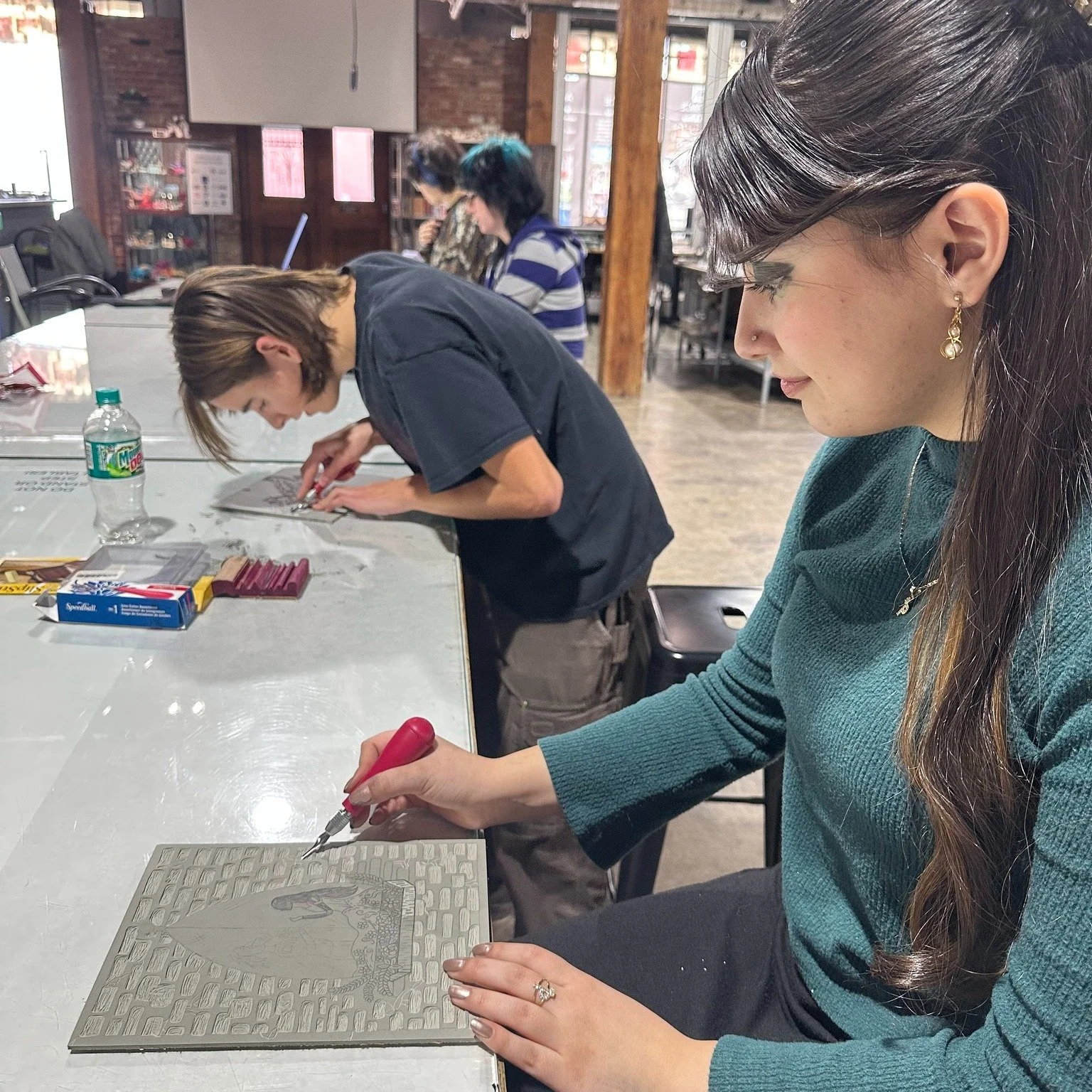 Students carve and work with their mentor