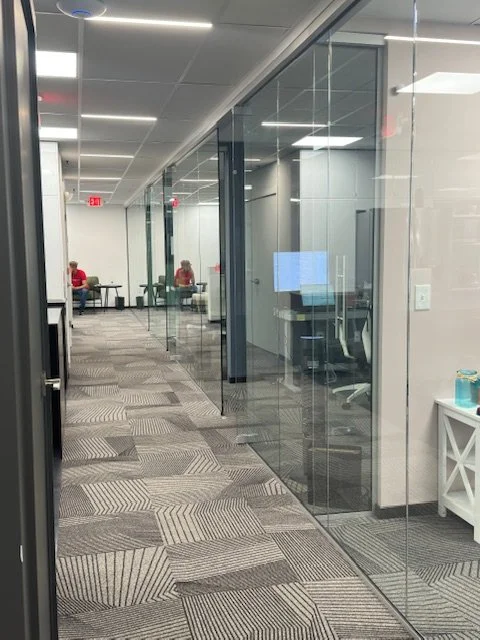 hallway view with glass office partition 