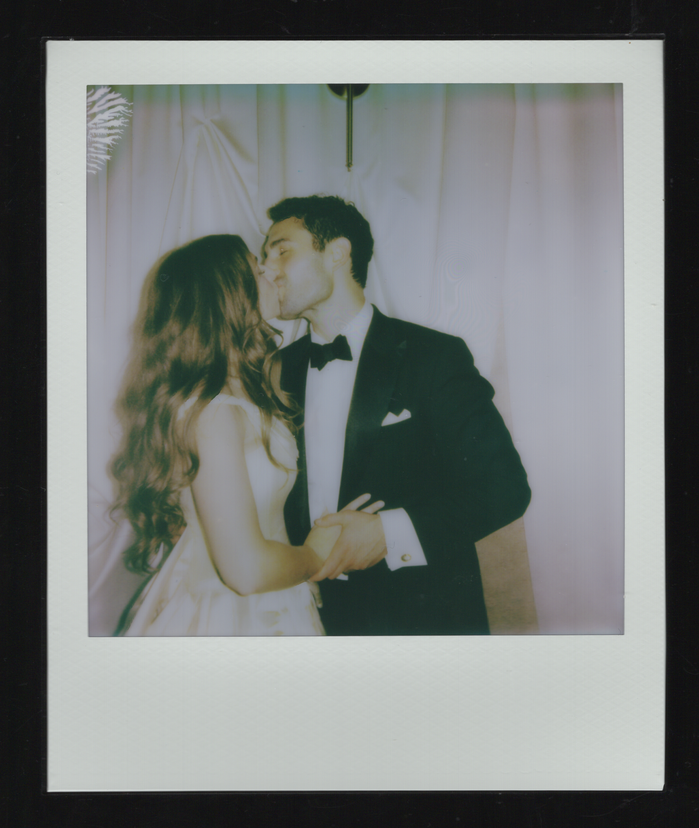 polaroid of couple kissing at a wedding