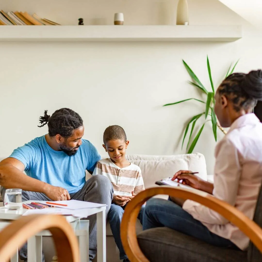 Therapy session showing therapist, dad and child.