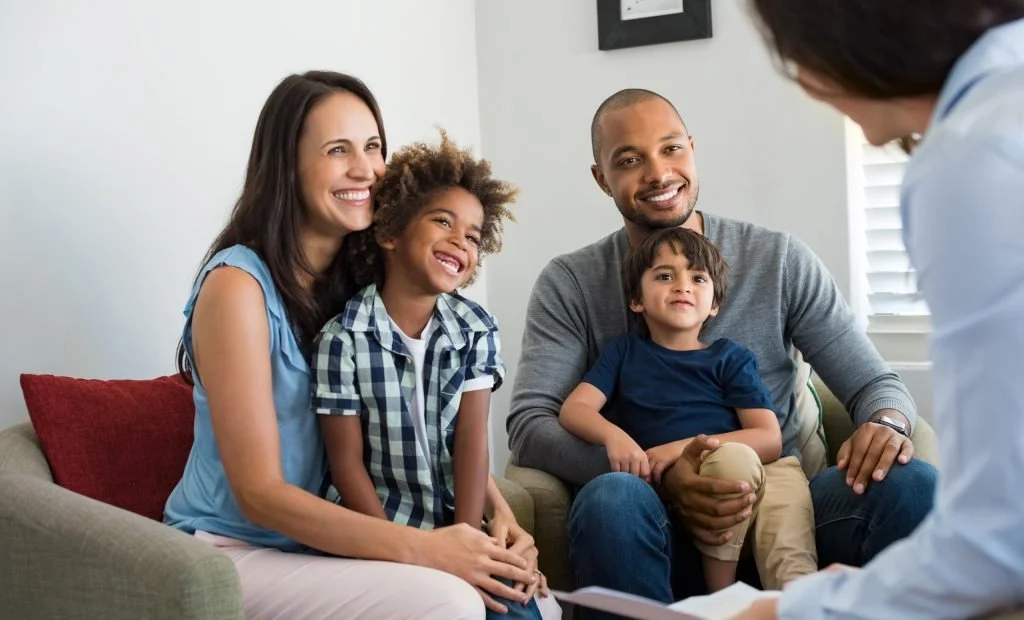 Family sitting in couch for parent coaching session. Christian parent coaching available in North and South Tampa, FL.