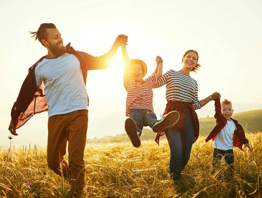 Family walking together with sun shining through, connecting parent coaching at Christian Counseling of Tampa.