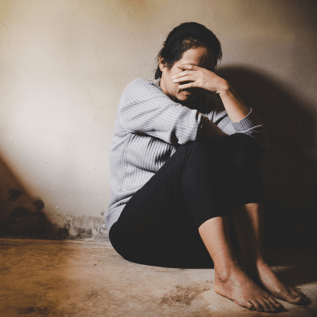 Woman sitting with her hand over her head.  If you are needing trauma therapy in Tampa, FL schedule with a trained EMDR or ART therapist at Christian Counseling of Tampa.