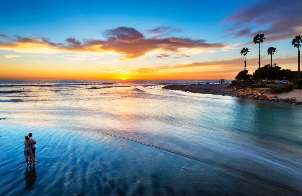 Couple watching the sun set at their destination proposal spot.jpg