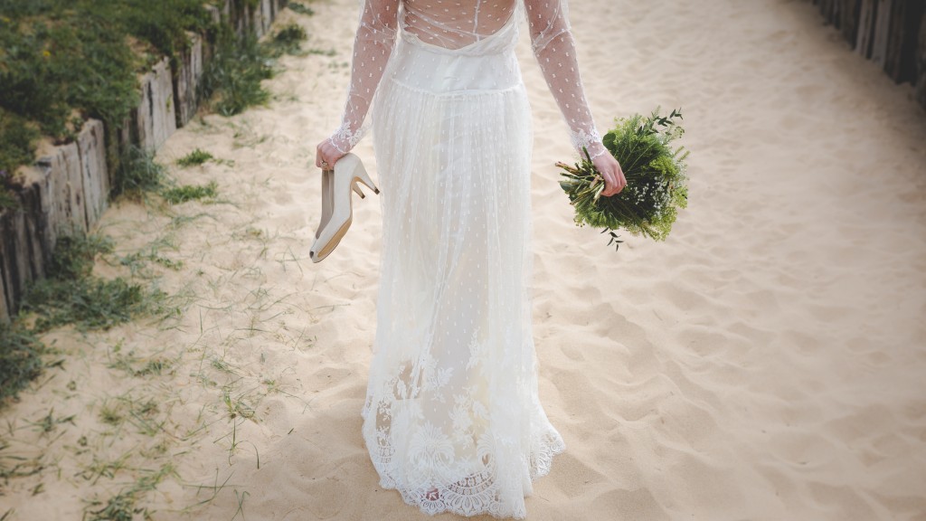 A bride walking down the beach after marrying in Bali.jpg