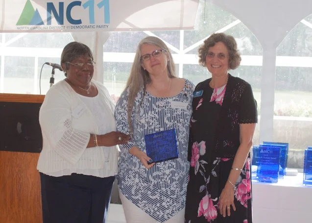 Minority Affairs Chair of NC11, Gale Jones presenting the Liston B. Ramsey Award to Burke County Chair, Pam Genant