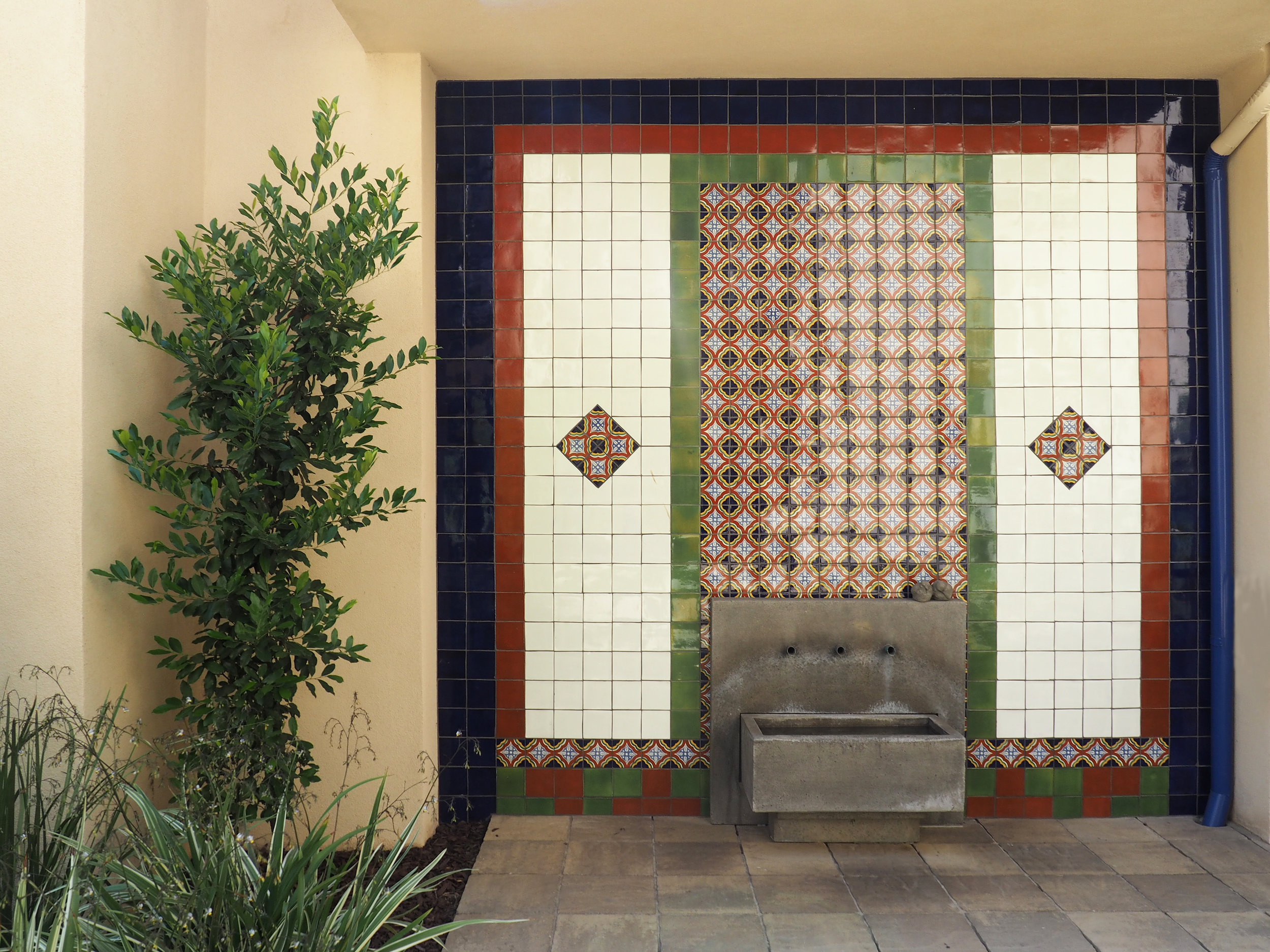 Tiled wall with fountain at Marv's Place Apartments