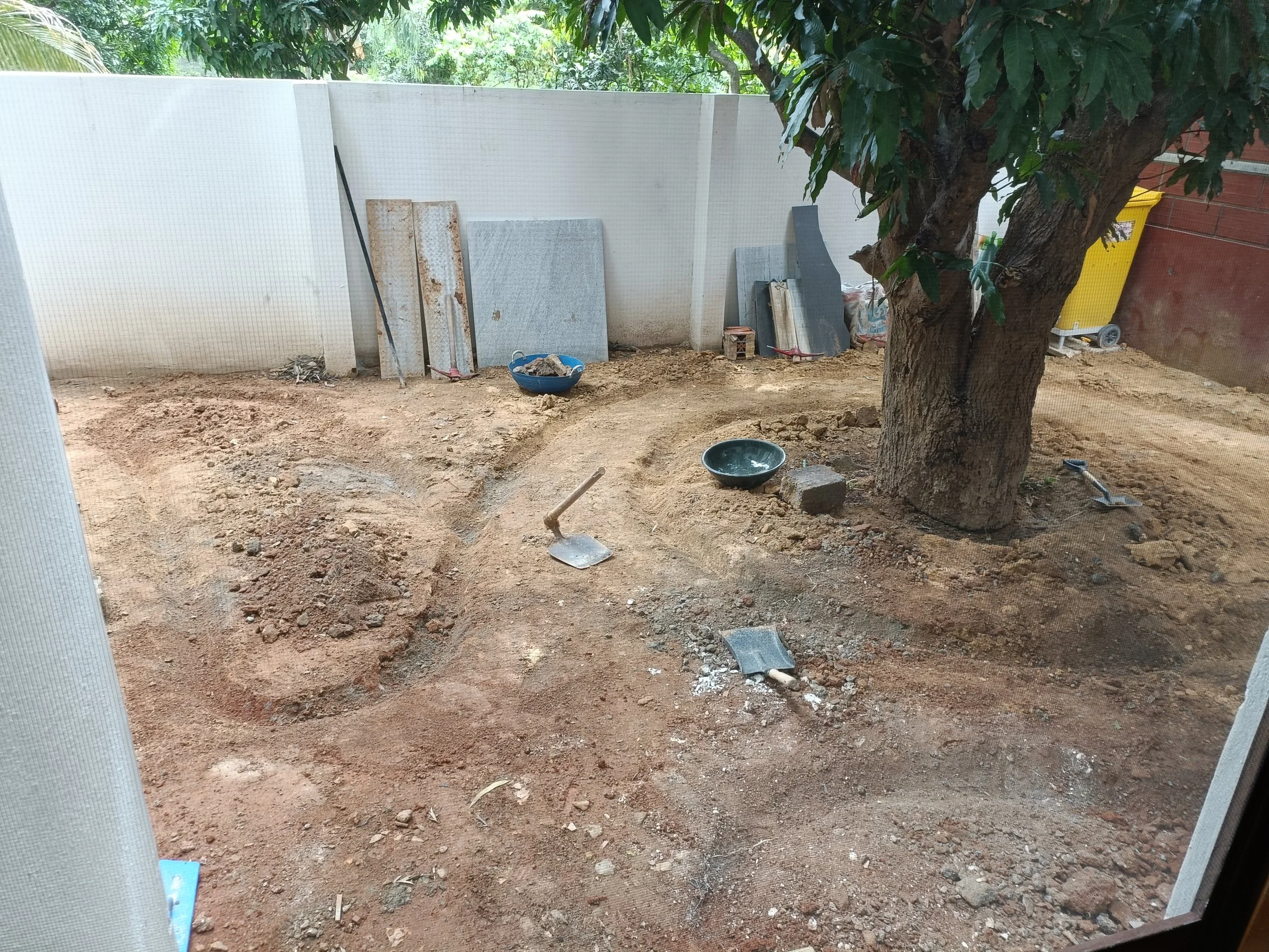 Digging trench to place bricks for pathways and beds