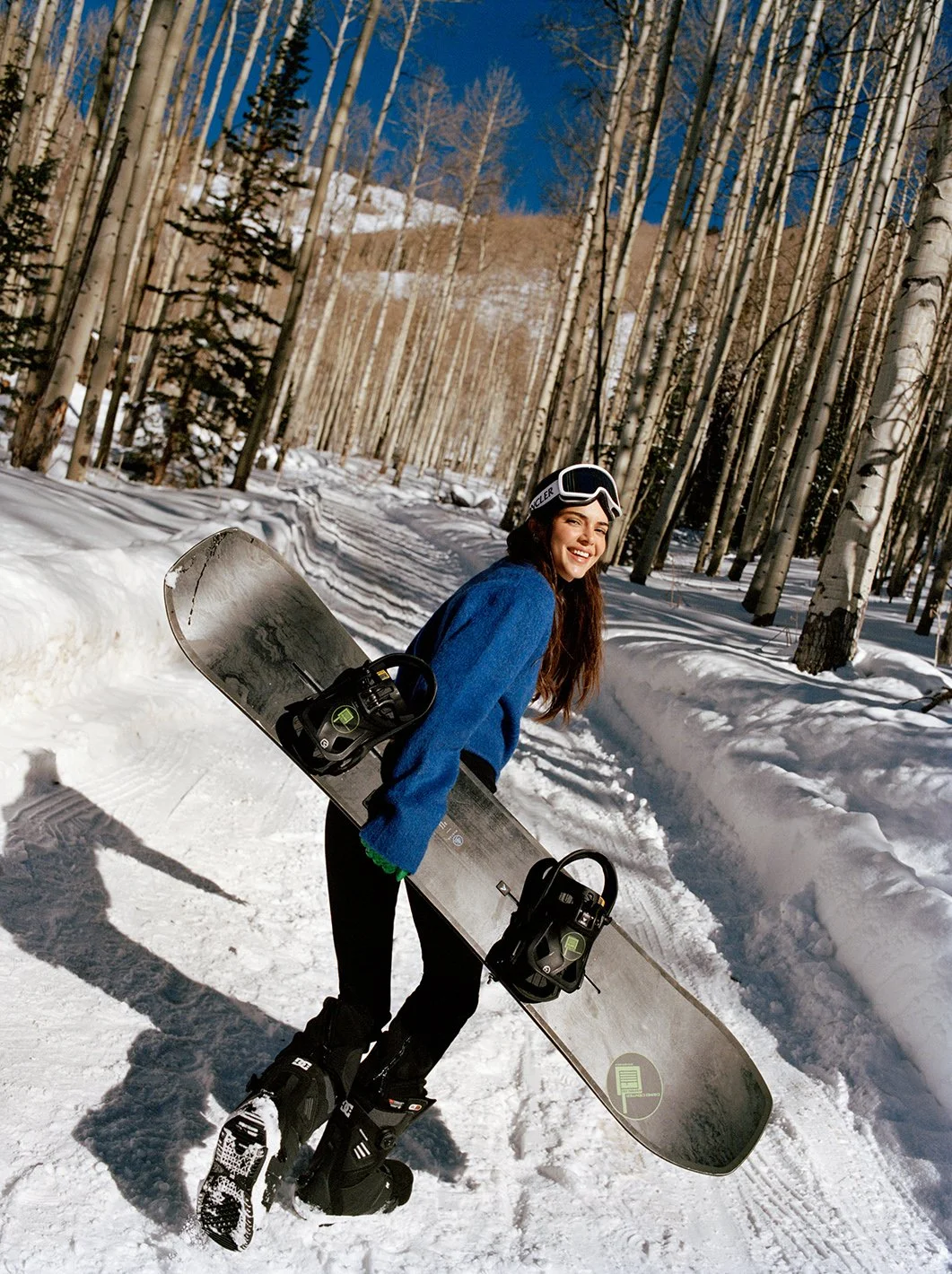  Kendall Jenner in a blue-and-black winter look seated in the snow among Aspen trees for FWRD, photographed by Sean Thomas. 