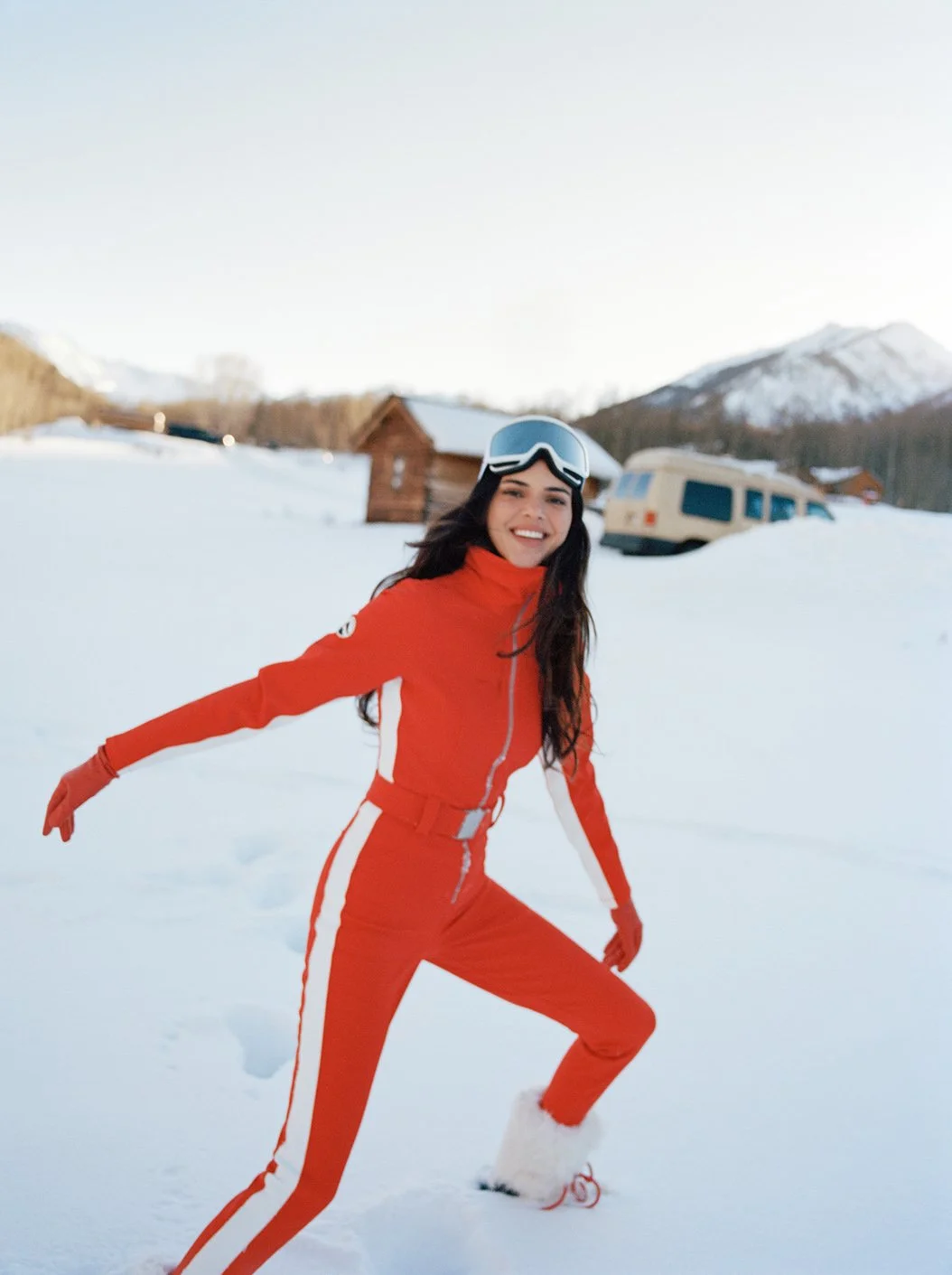  Kendall Jenner moving through fresh Aspen snow in a red ski suit for FWRD, photographed by Sean Thomas. 
