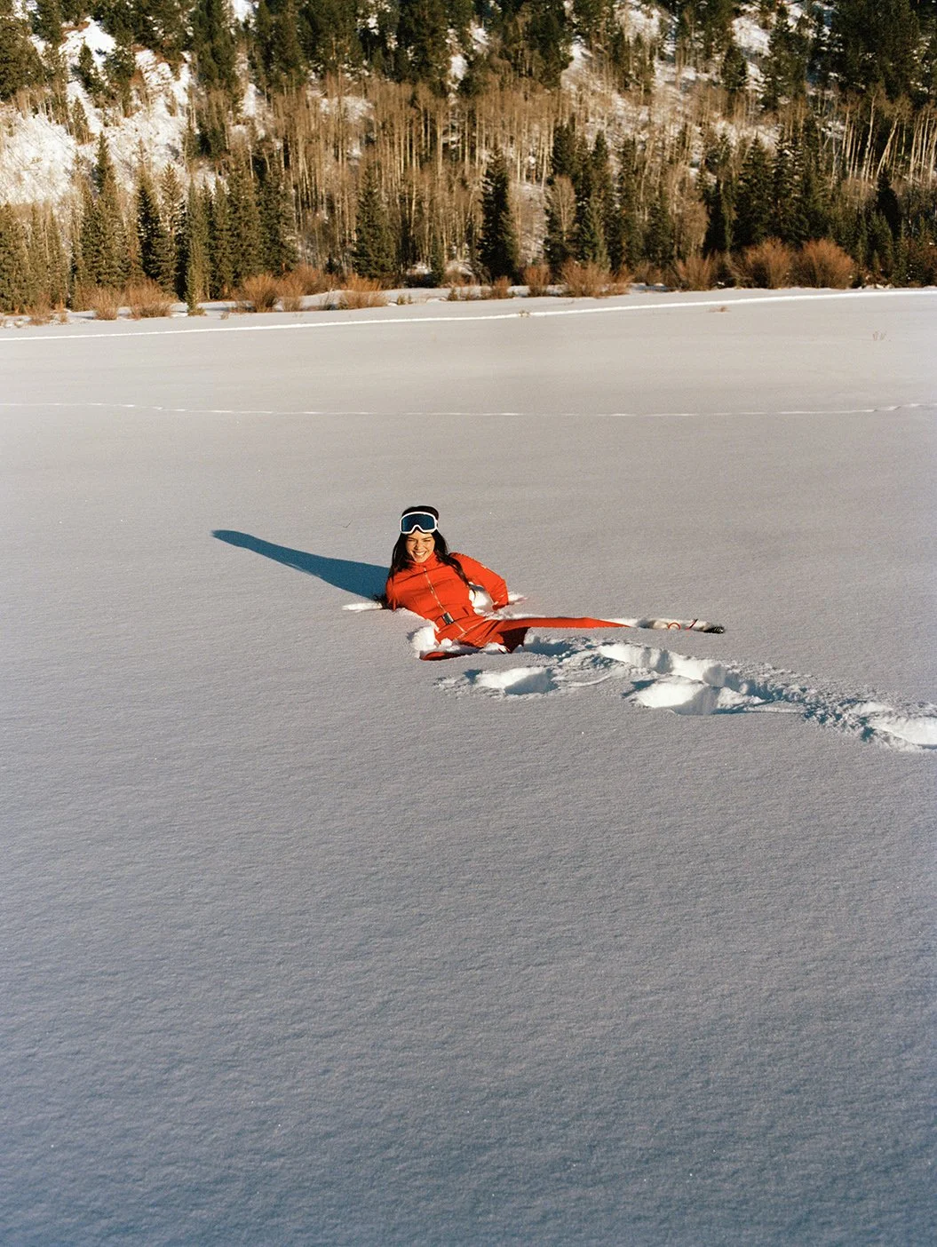  Kendall Jenner reclining in pristine Aspen snow in a red ski suit for the FWRD campaign, photographed by Sean Thomas. 