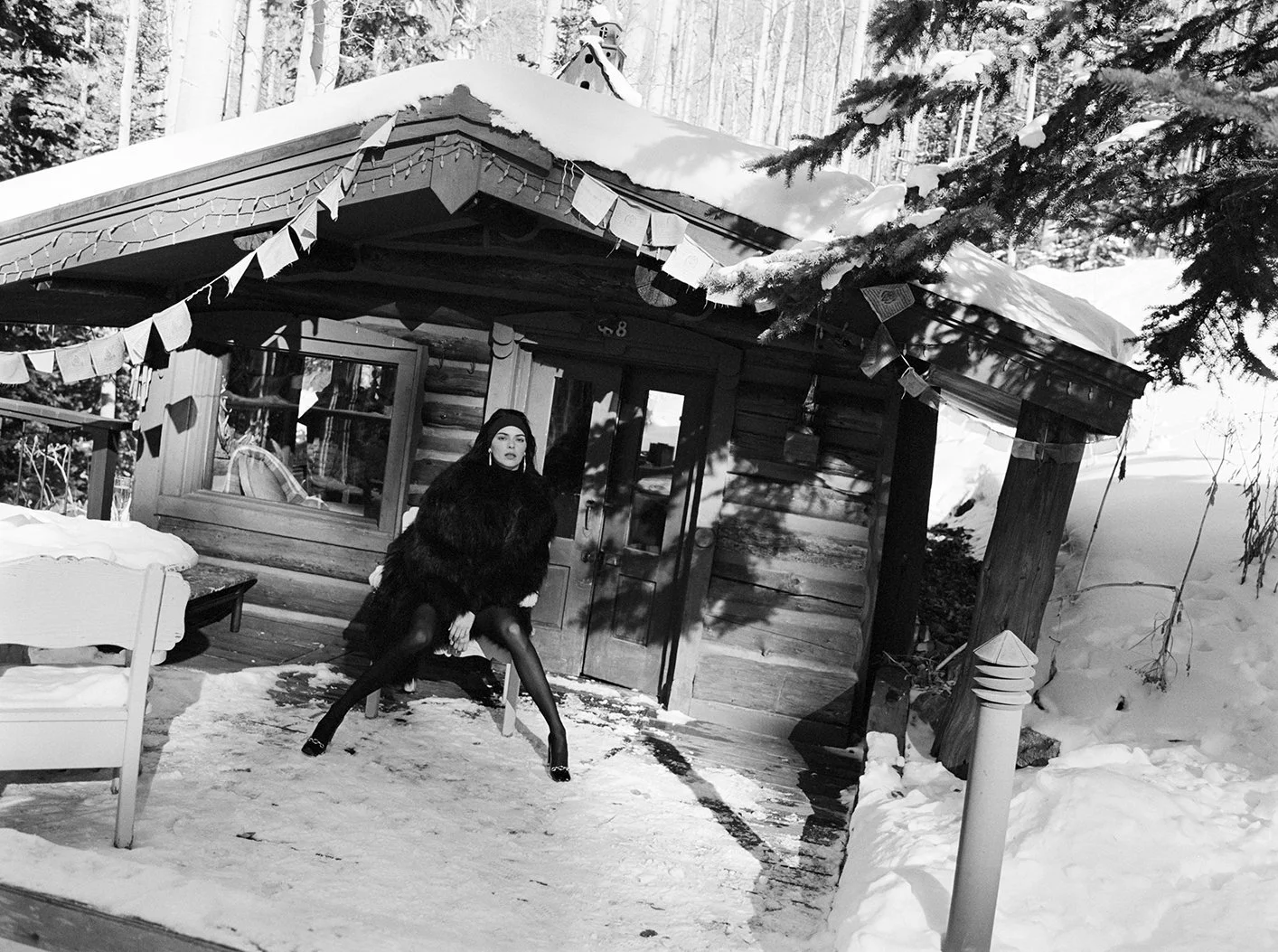  Black-and-white portrait of Kendall Jenner in a dark winter look outside a snow-covered Aspen cabin for FWRD, photographed by Sean Thomas. 