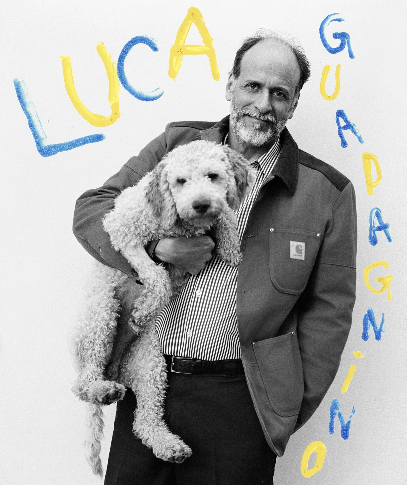 Black-and-white portrait of filmmaker Luca Guadagnino holding his curly-haired dog against a hand-painted blue-and-yellow backdrop, photographed by Sean Thomas for Door magazine. 