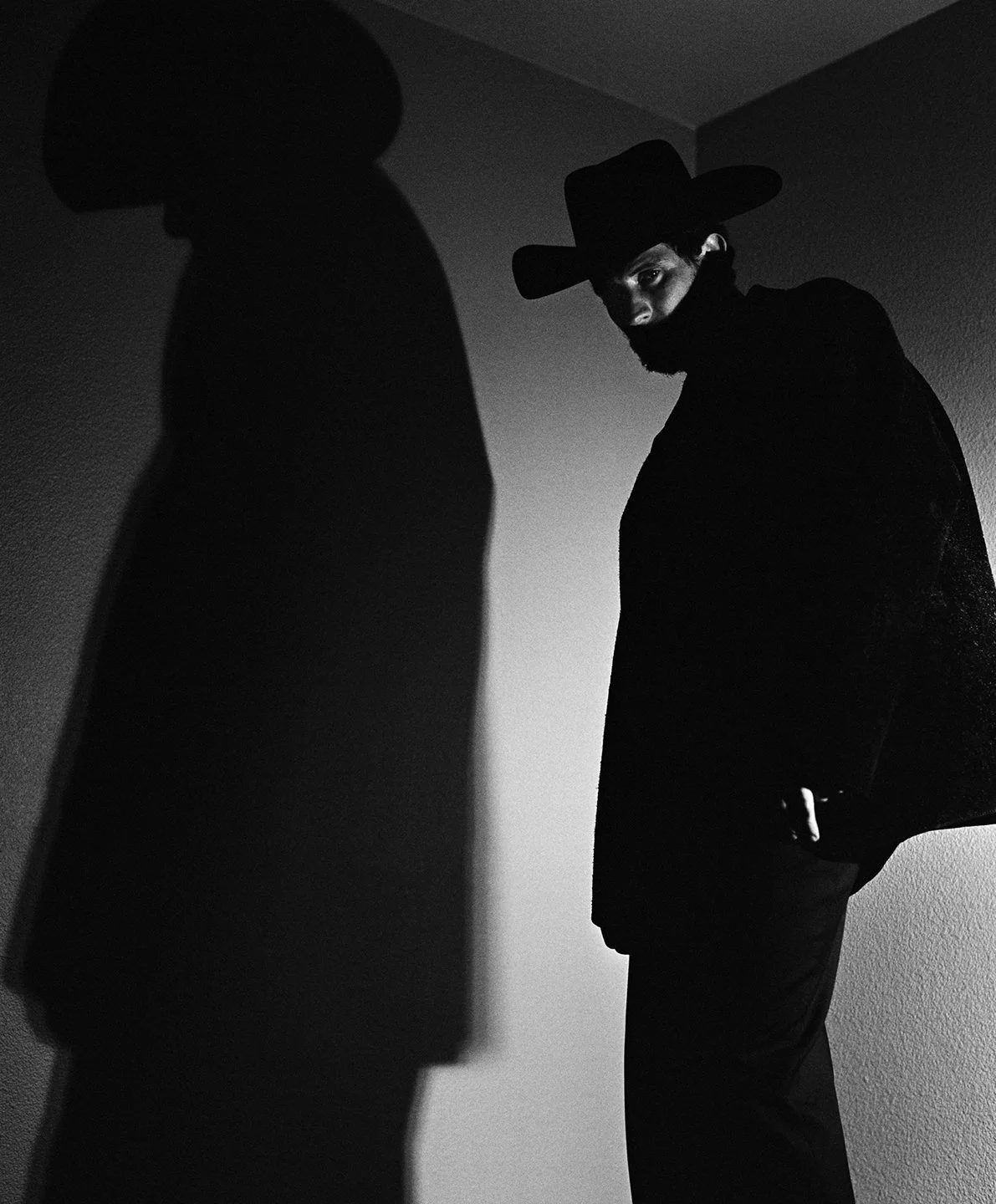  Shadowed black-and-white portrait of Josh O’Connor in a cowboy hat, photographed by Sean Thomas for WSJ. Magazine. 