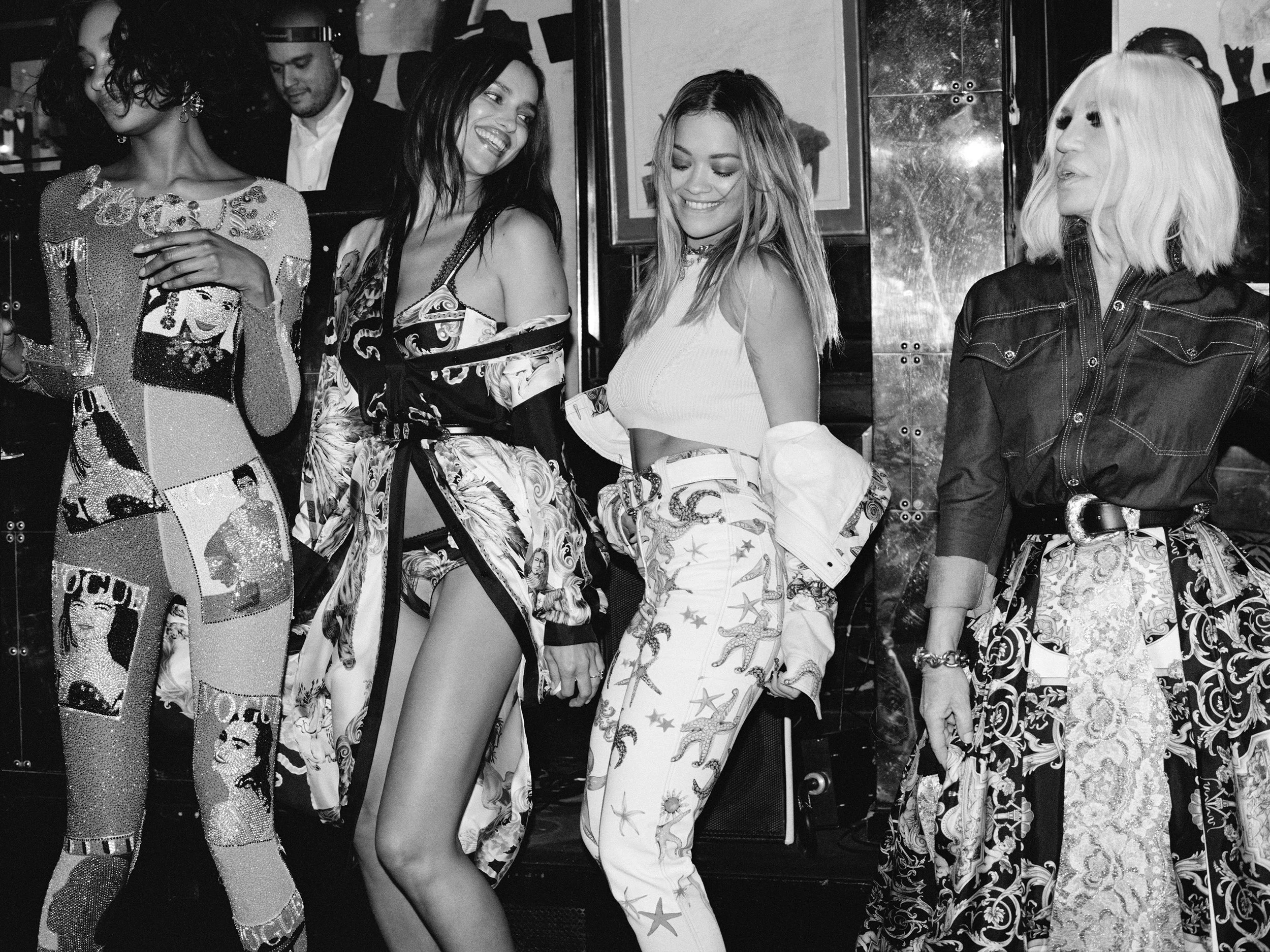  Donatella Versace and the British Vogue cast on the dance floor at Annabel’s, London, wearing Versace prints. “Queen of the Night,” photographed by Sean Thomas and styled by Jack Borkett, April 2018. 