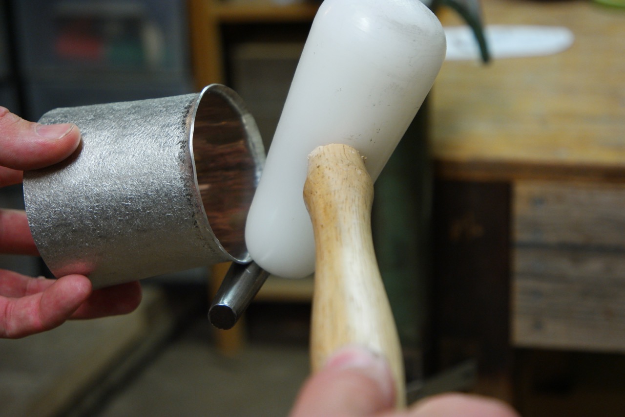  With the top and bottom edges true, I begin to form the rim over the narrowest section of the of the blow horn stake.     