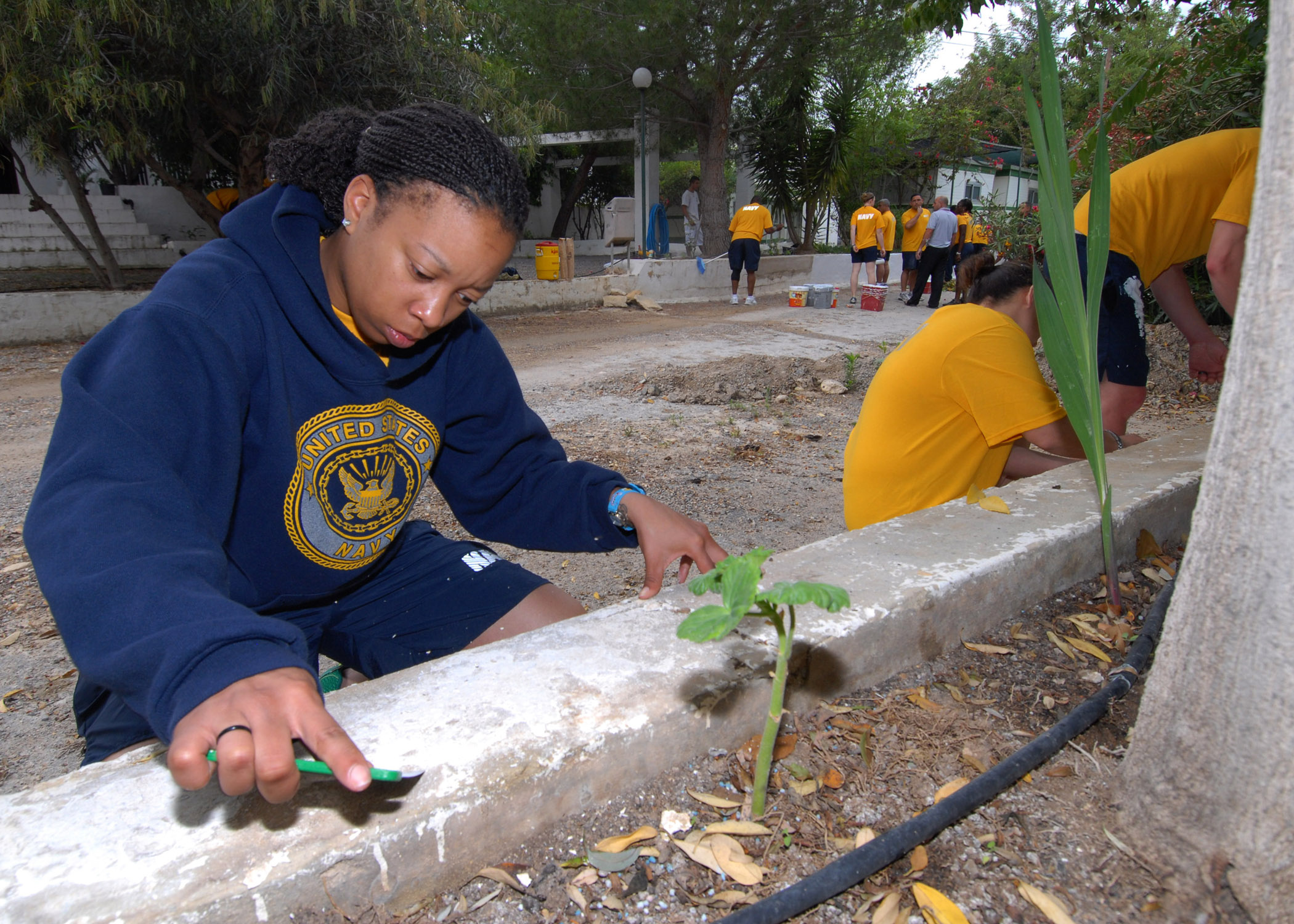 US_Navy_110608-N-DU438-118_Culinary_Specialist_2nd_Class_Ashley_S._Colbert_scrapes_paint_from_a_ledge_as_part_of_a_community_service_project_during.jpg