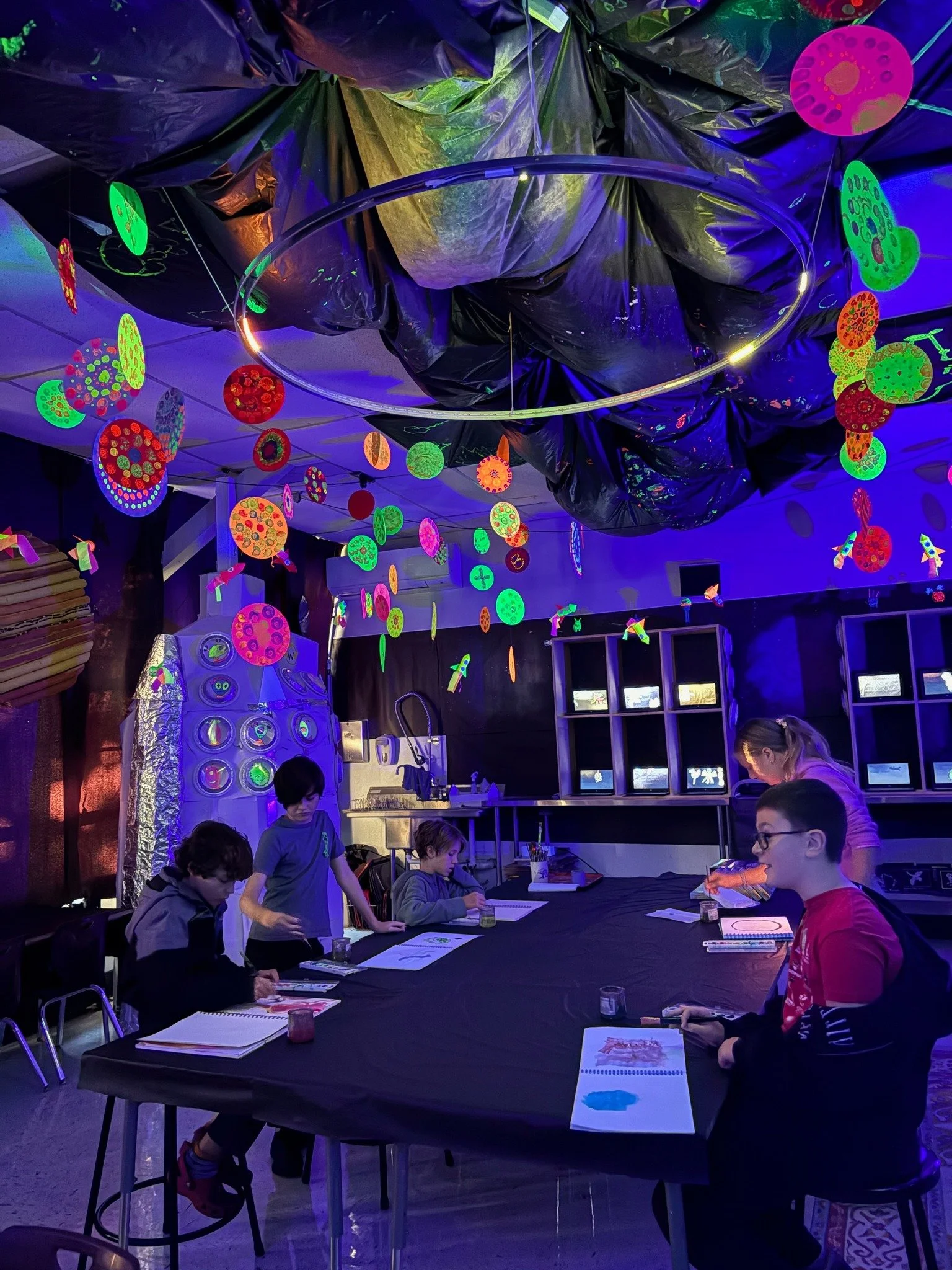 🚀✨ Our K&ndash;8 students launched their creativity into orbit with an incredible space-themed art installation! From planetary paintings and glowing blacklight galaxies to rocket ships, aliens, and a space shuttle that lets students blast off into 