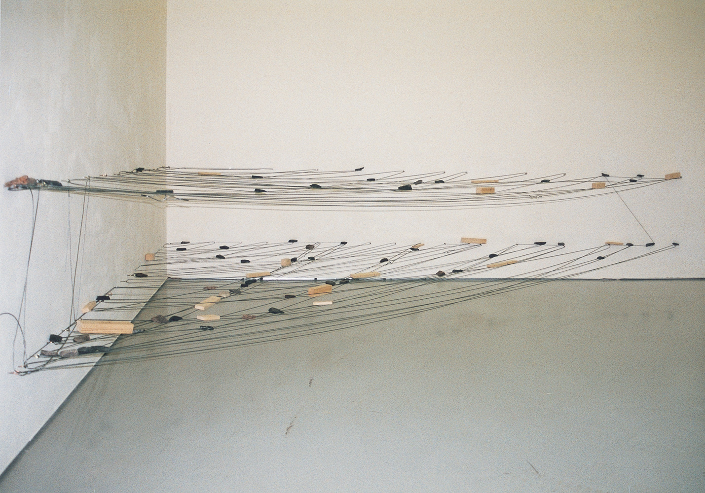 Left-Behind Situation , 1972/1996 捨置状況 ( Shachi Jōkyō ) Wood, stone, wire rope Dimensions variable Installation view, Matter and Perception 1970: Mono-ha and the Search for Fundamentals , Musée d’art moderne Saint-Étienne, 1996 Photo: Tsuyoshi Satoh