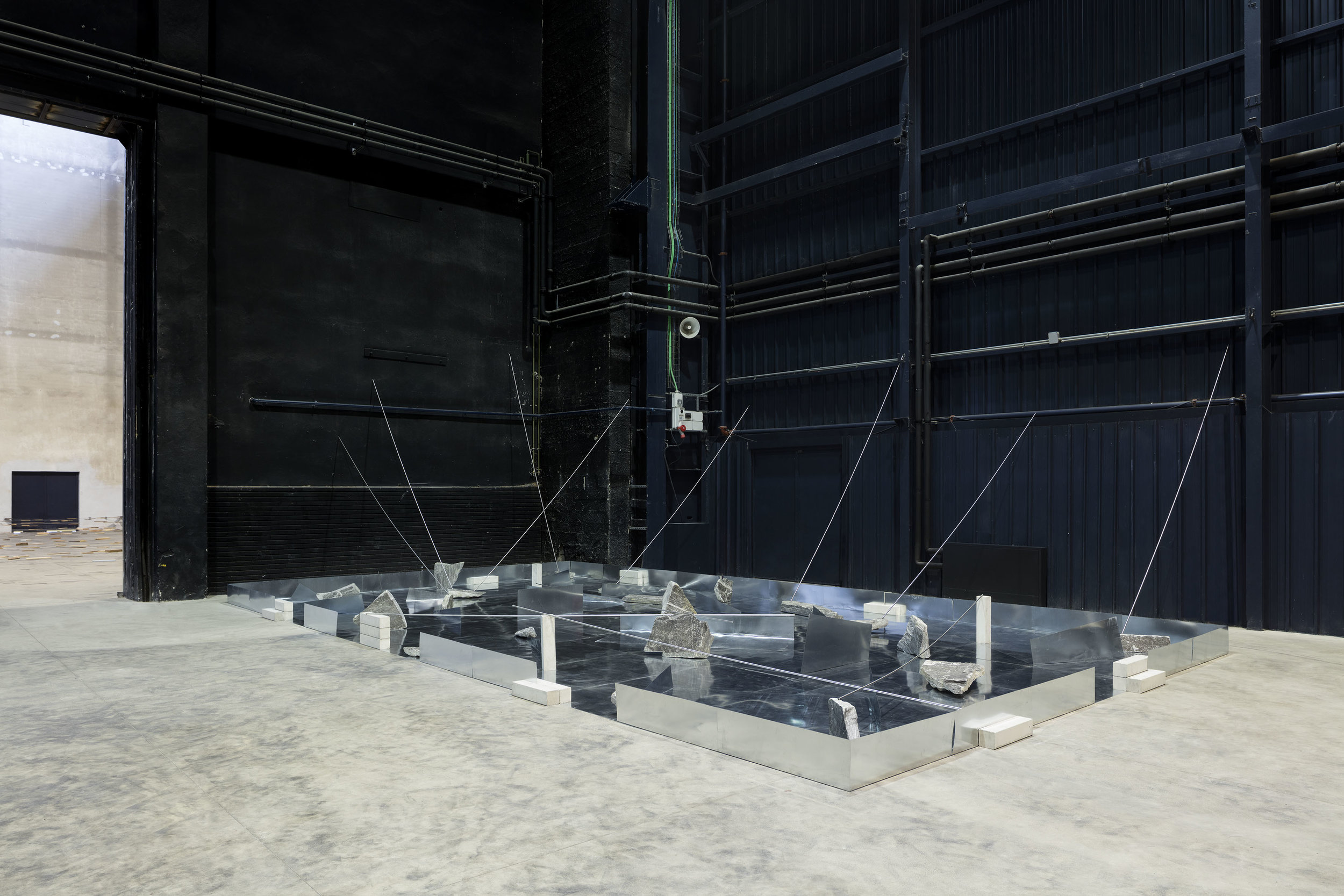Separating Dependence , 1973/2013 依存差 ( Izonsa ) Zinc plates, steel bars, concrete blocks, stones 415 x 1026 x 568 cm Installation view, Kishio Suga: Situations , Pirelli HangarBicocca, Milan, 2016 Photo: Agostino Osio; Courtesy Pirelli HangarBicocca, Milan