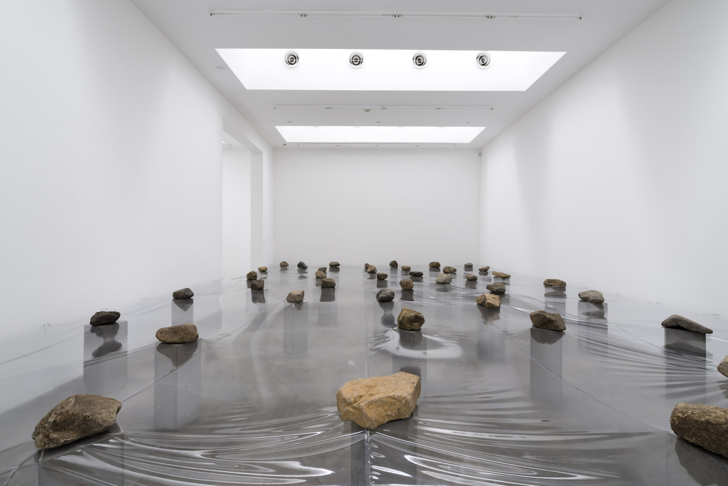 Law of Multitude , 1975/2012 多分律 ( Tabunritsu ) Plastic sheet, stone, concrete 33 x 258 x 349 inches overall Installation view, Blum & Poe, Los Angeles, 2012 Photo: Joshua White/JWPictures.com Courtesy Blum & Poe, Los Angeles / New York / Tokyo