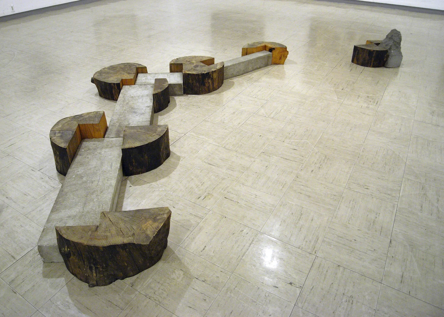 Kishio Suga, Spreading Wood '86 (1986), wood, stones. 440 x 240.0 x 42.5 cm. Installation view at Yokohama Civic Art Gallery, 1996. Photo: Tsuyoshi Satoh.
