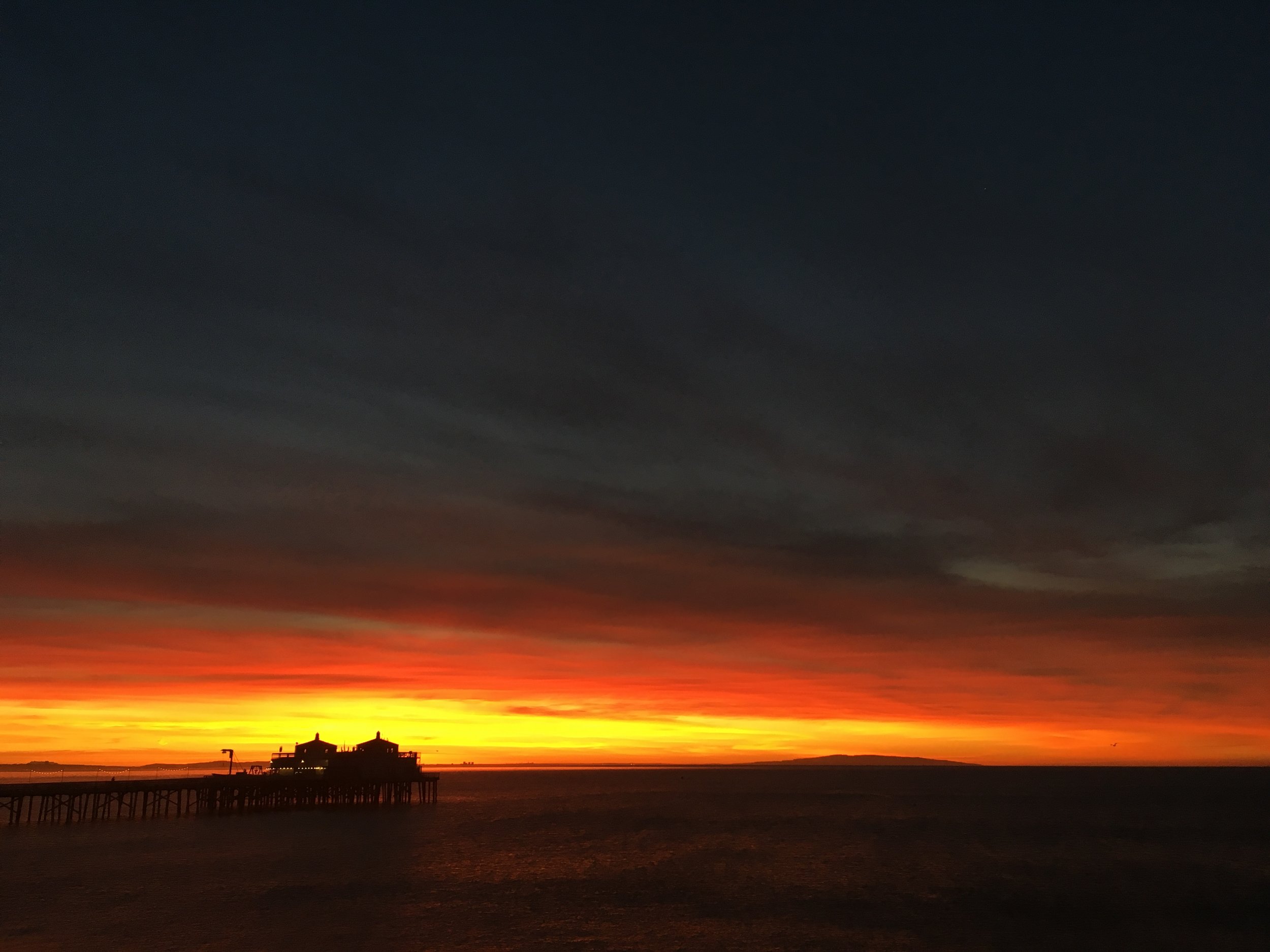 sunrise over lifeguard station on beach
