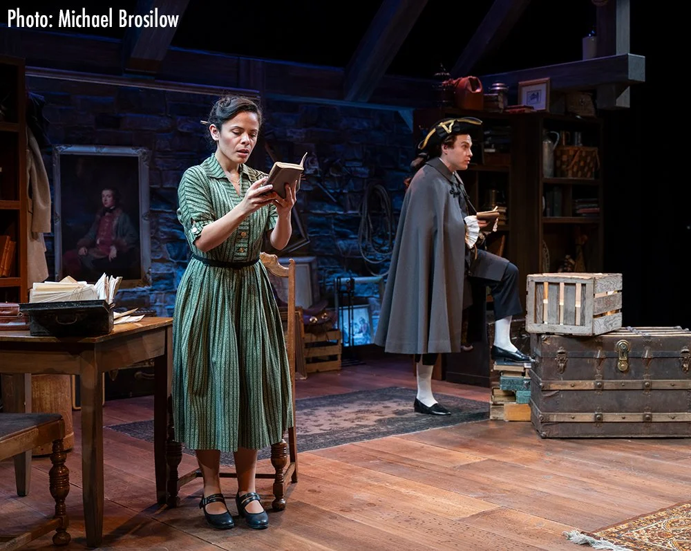 Madeline Caleis-King as Joan reading Boswell's journal with Josh Krause as Boswell in the background.