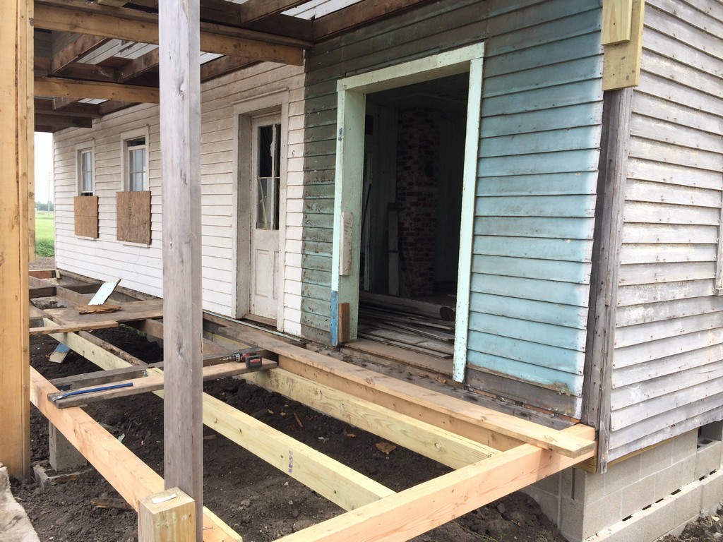 The opening shown here was originally a window. It accessed an extension of the kitchen when the lower porch was enclosed.