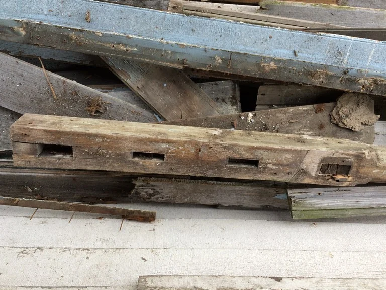 Mortices in lower porch post indicate that the lower porch had railings as well as the upper porch.