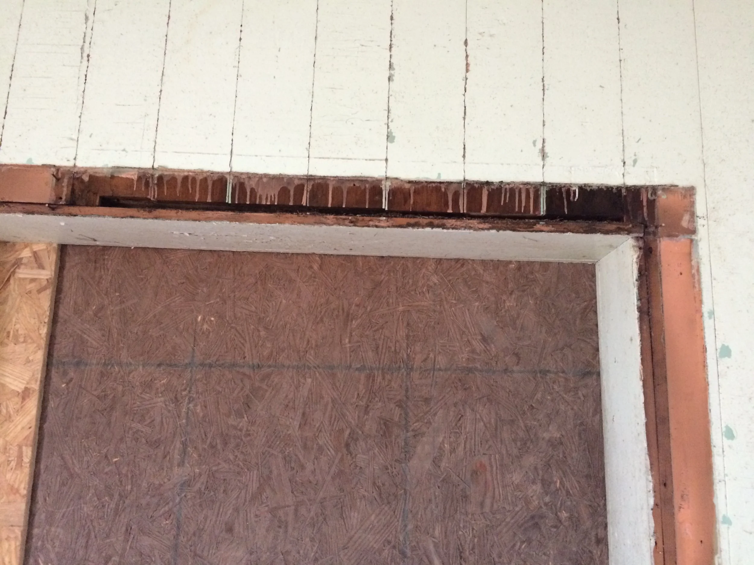 Removal of facing trim on the door opening revealed evidence of an original window.