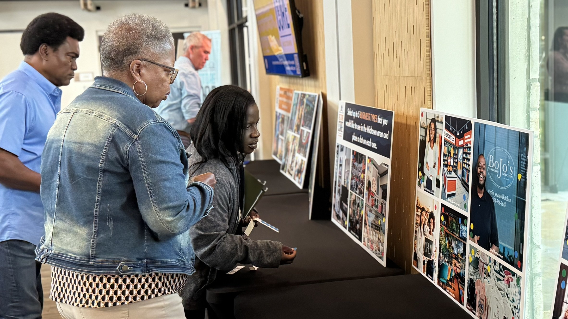 people looking at the interactive station at midtown public meeting